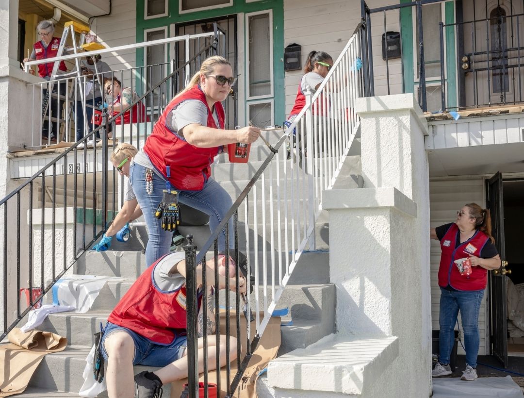 Lowe's volunteers making home repairs with Rebuilding Together