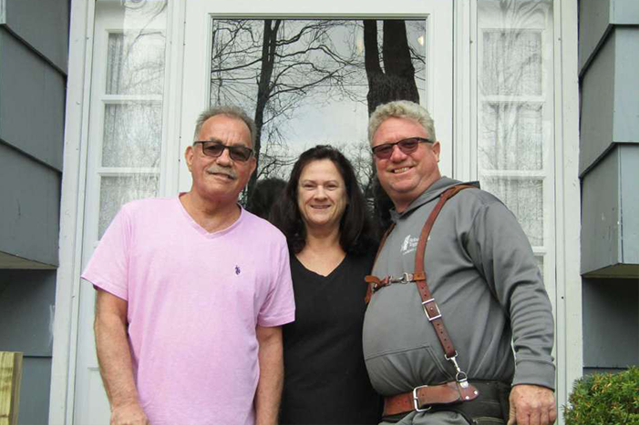 George and Karen Zigmantanis, center and left, are joined by Michael Boges, chairman of Rebuilding Together of Litchfield County.