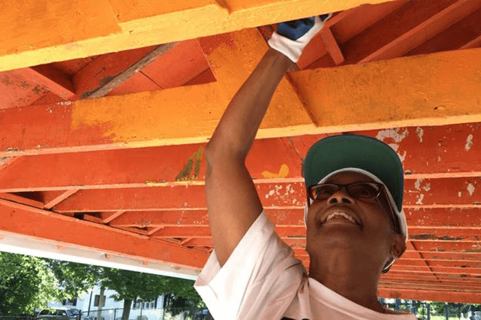 Donna Blackwell, president of the York Road Partnership, volunteers to help paint the pavilion at Willow Avenue Park during a two-day community improvement event in the Wilson Park neighborhood organized by Rebuilding Together Baltimore. (Sarah Gantz / The Baltimore Sun)