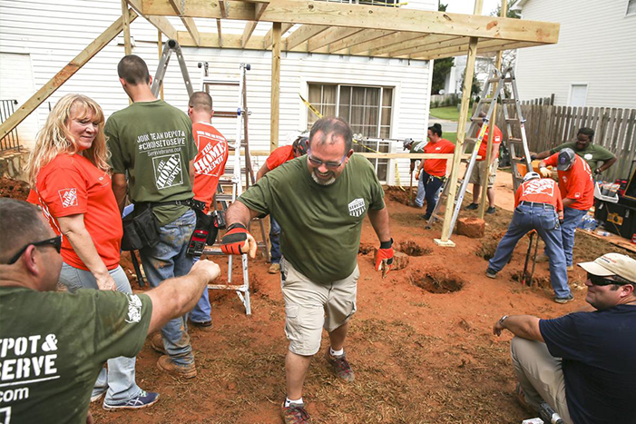 Tim Wightman (center), the Garrisonville Road Home Depot's manager, fist bumps district manager Matt Bobbitt.